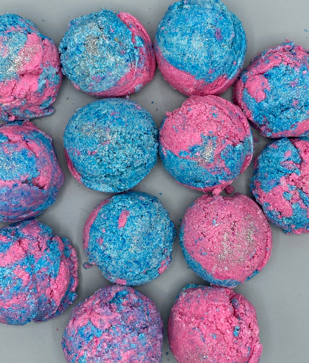 Picture of pink and blue solid bubble scoops on a grey background